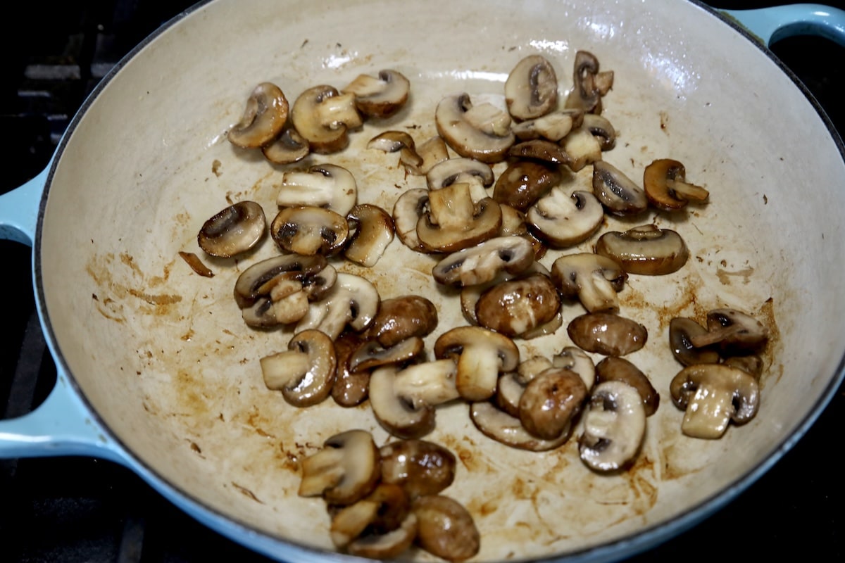 Skillet with sauteed mushrooms.