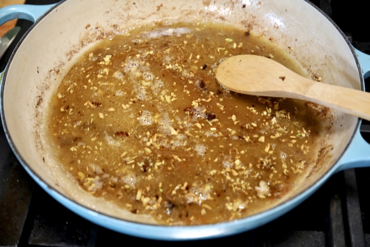 Chicken broth in a skillet.