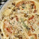 Pan of pork chops in creamy sauce.