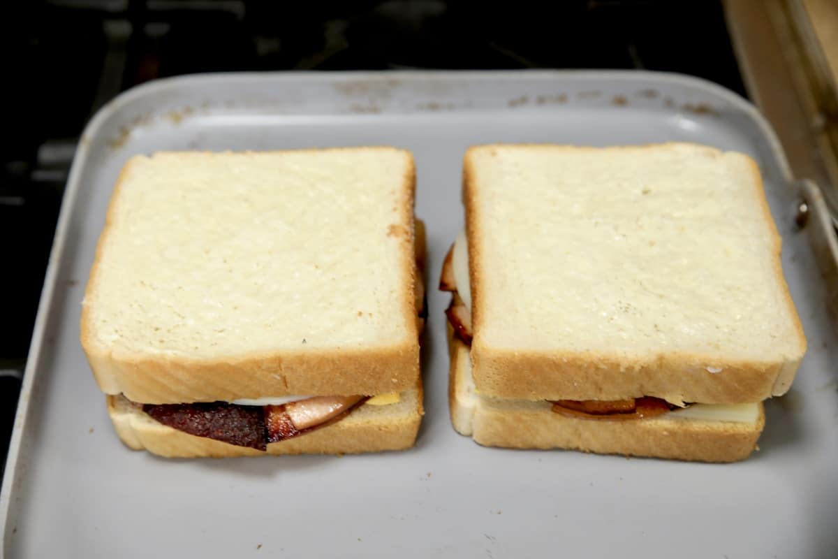 2 grilled cheese sandwiches on pan.