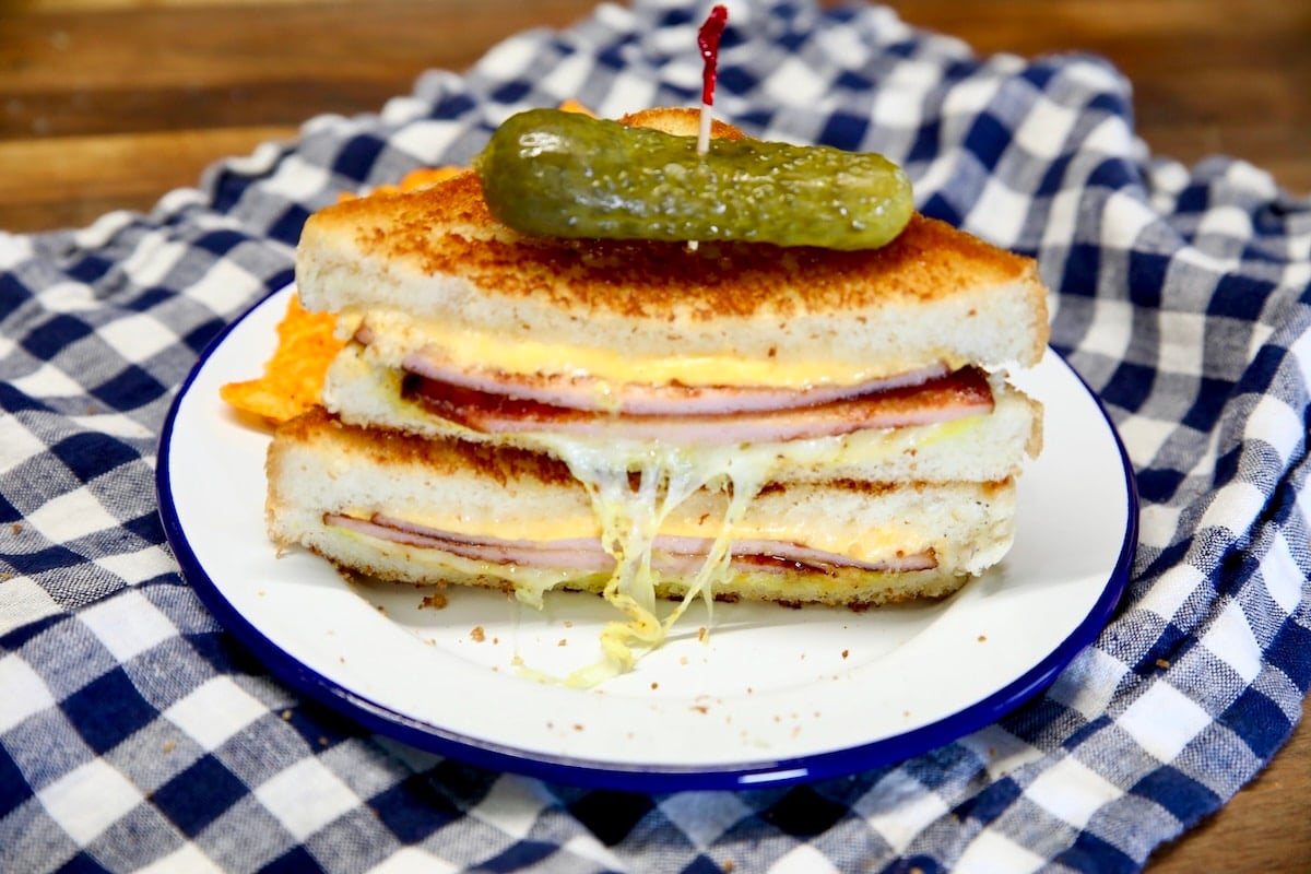 Bologna grilled cheese with pickle on top.
