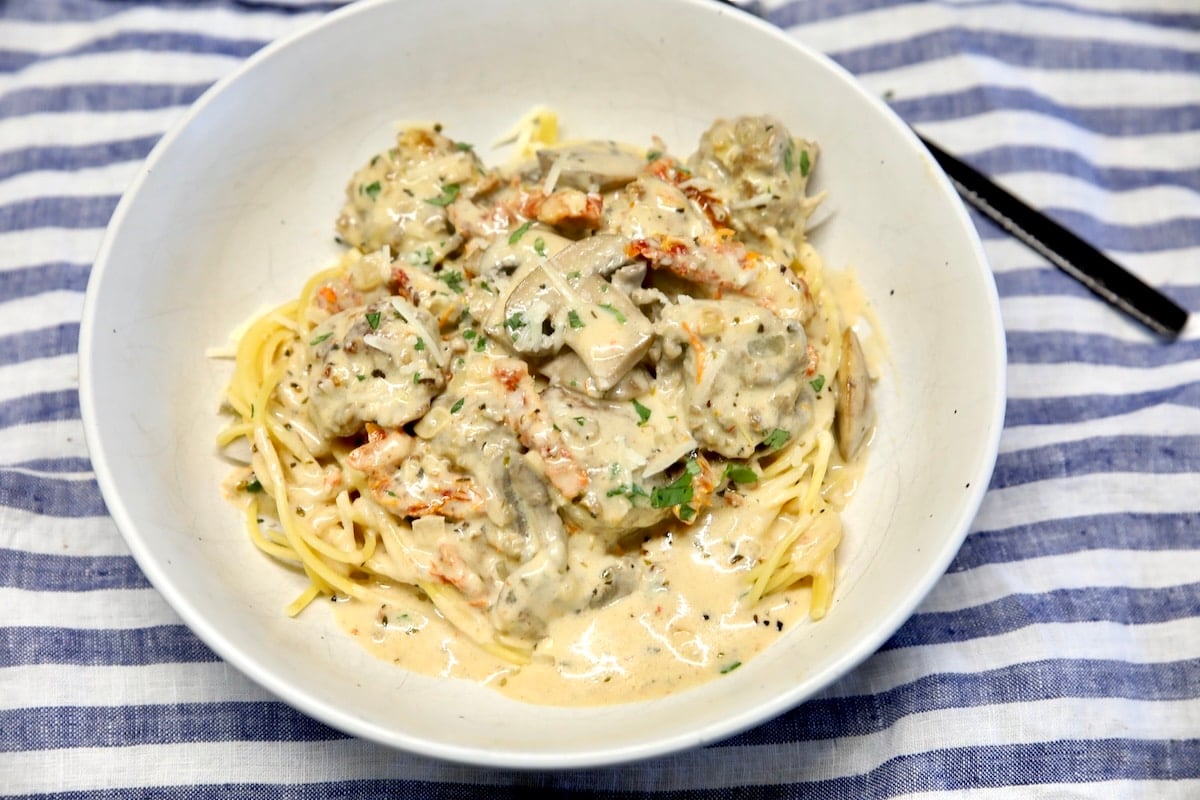Meatballs and spaghetti with creamy Italian sauce.