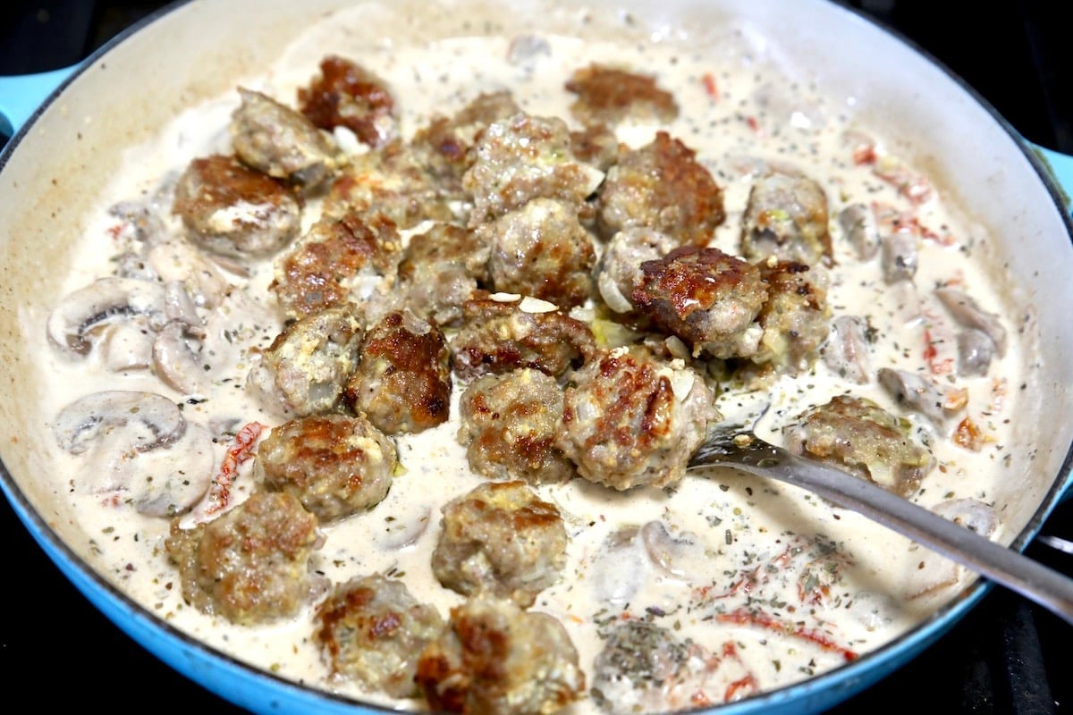 Cooking meatballs in cream sauce.