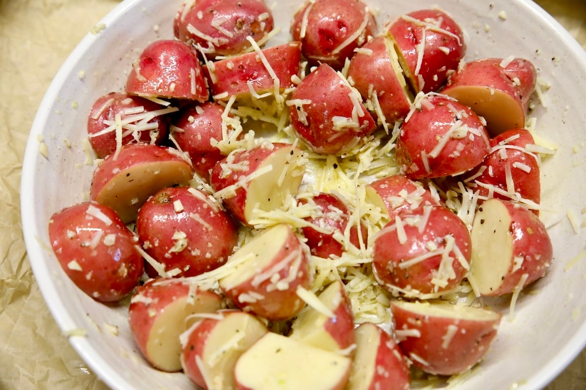 Bowl of parmesan coated potatoes.