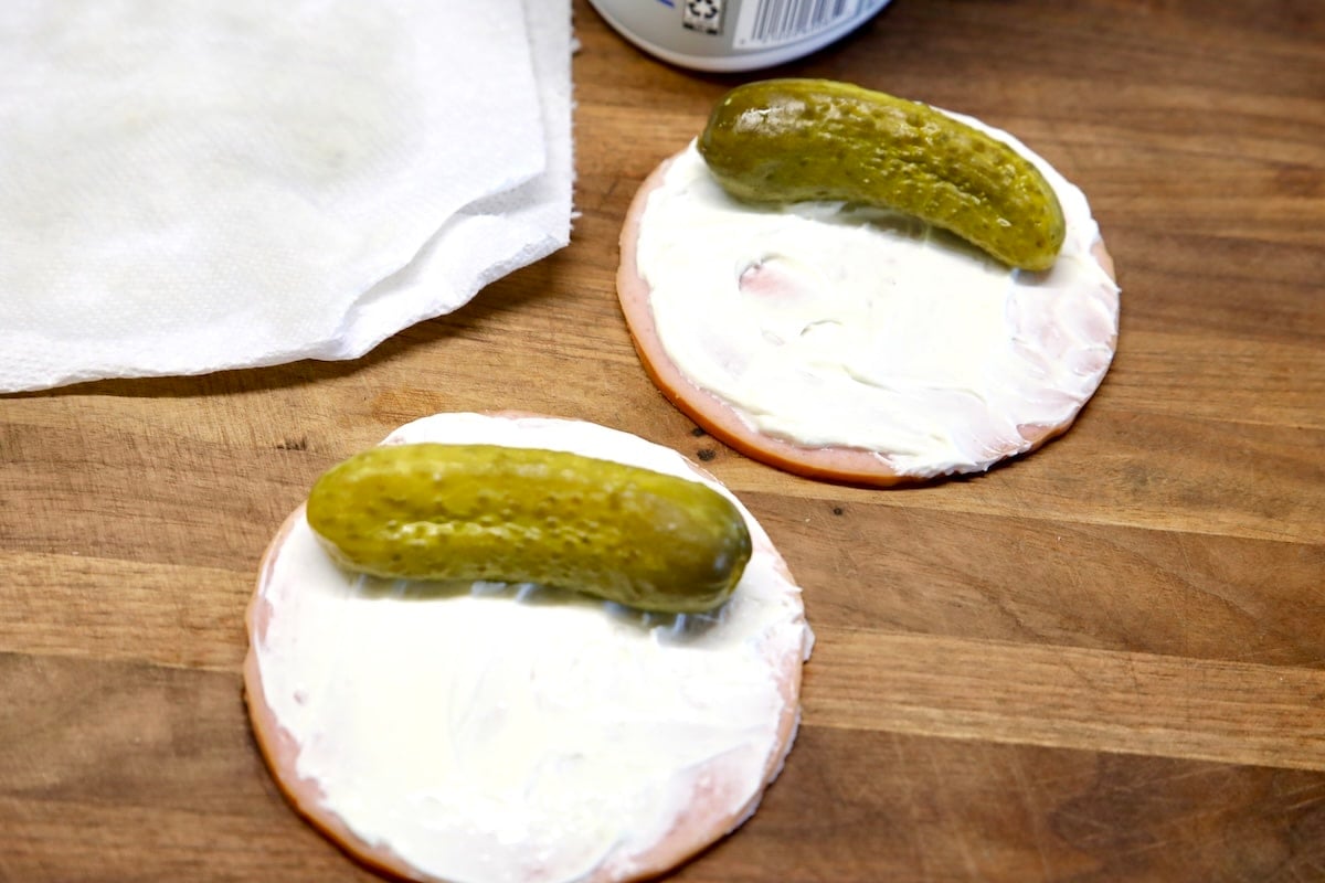 2 pickles on slices of bologna with cream cheese.
