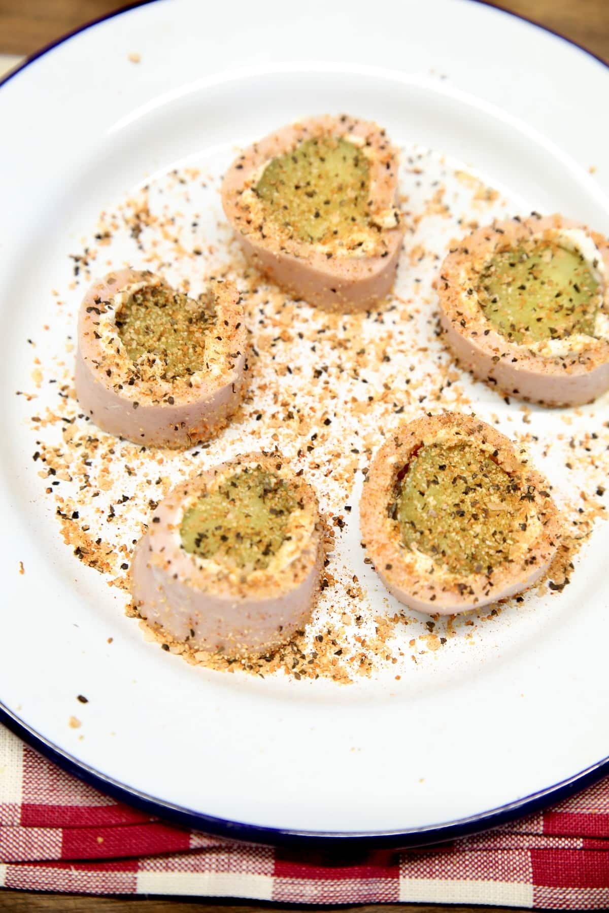 Plate of dill pickle bologna roll ups with seasoned salt.