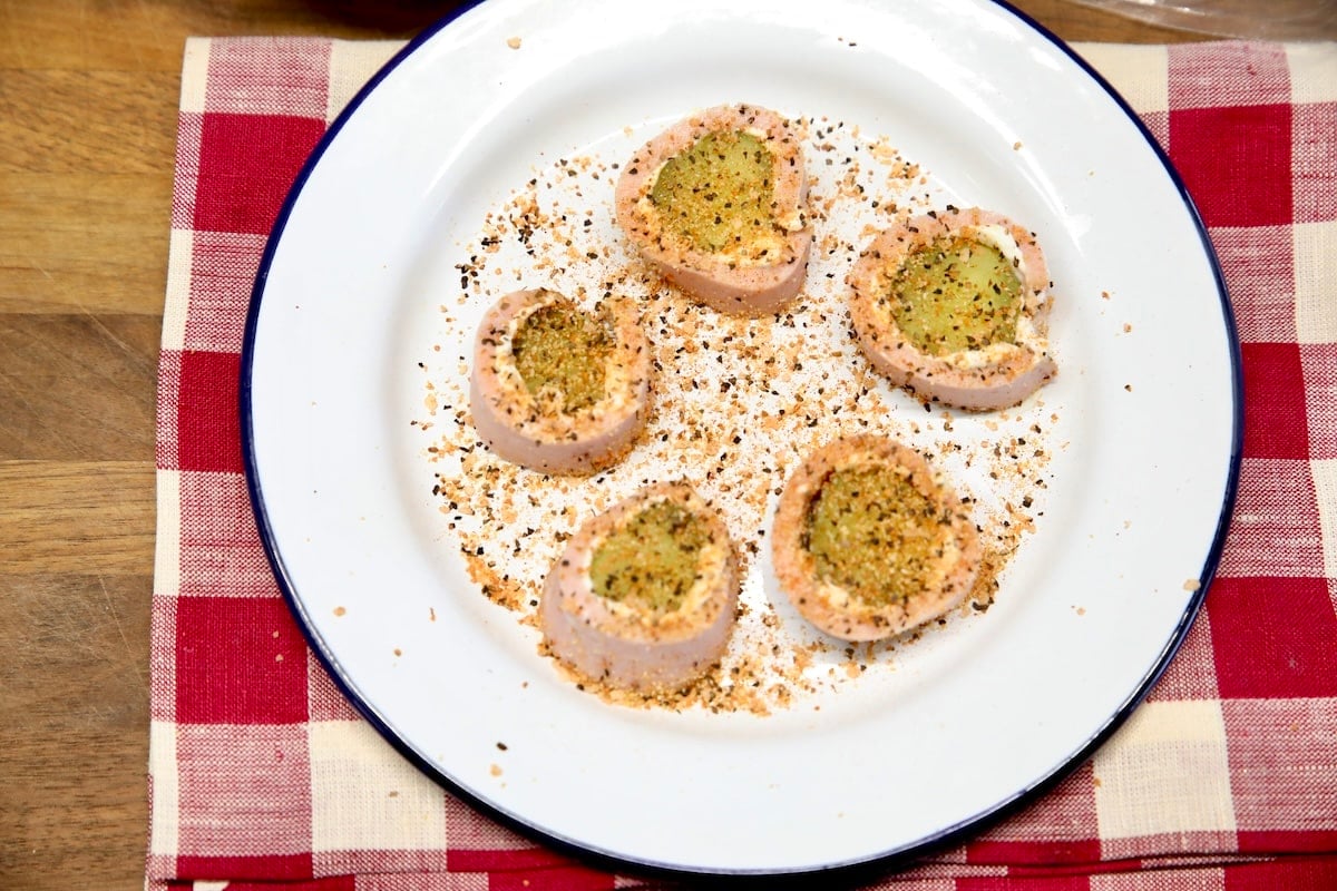 Plate of pickle roll ups with seasoning salt.