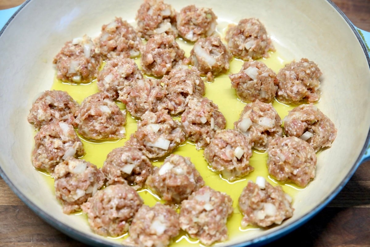 Cooking meatballs in a skillet.