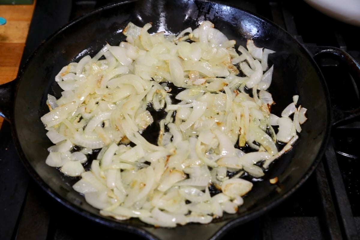 Sauteed onions in a skillet.