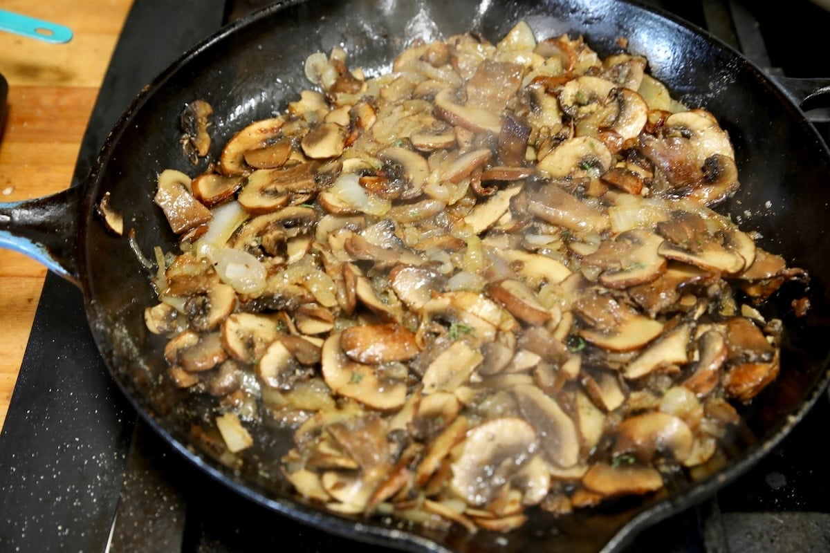 Sauteed mushroomsm in a skillet.