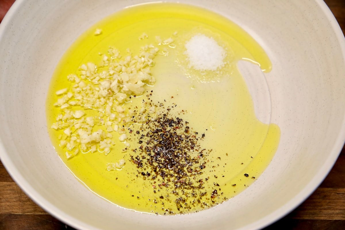 Olive oil and seasonings in a bowl. 