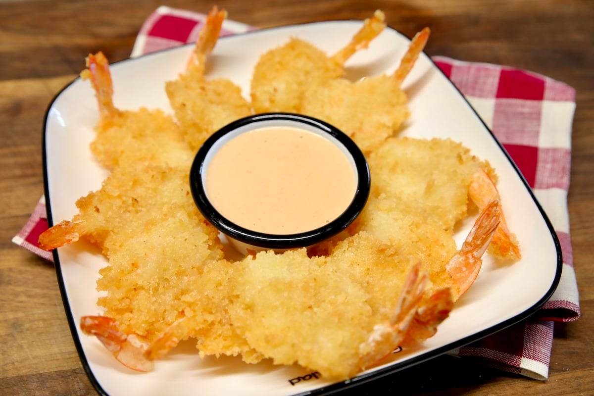Platter of shrimp with cup of shrimp sauce.