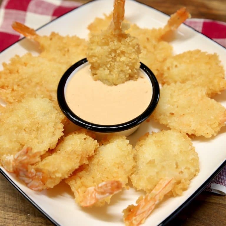 Fried shrimp platter with bowl of creamy shrimp sauce.