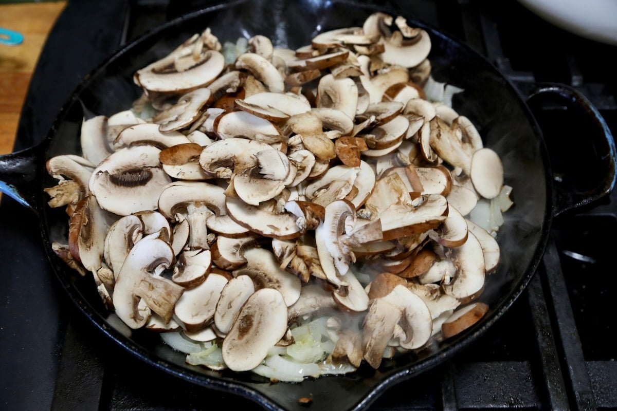 Sliced mushrooms in a skillet.