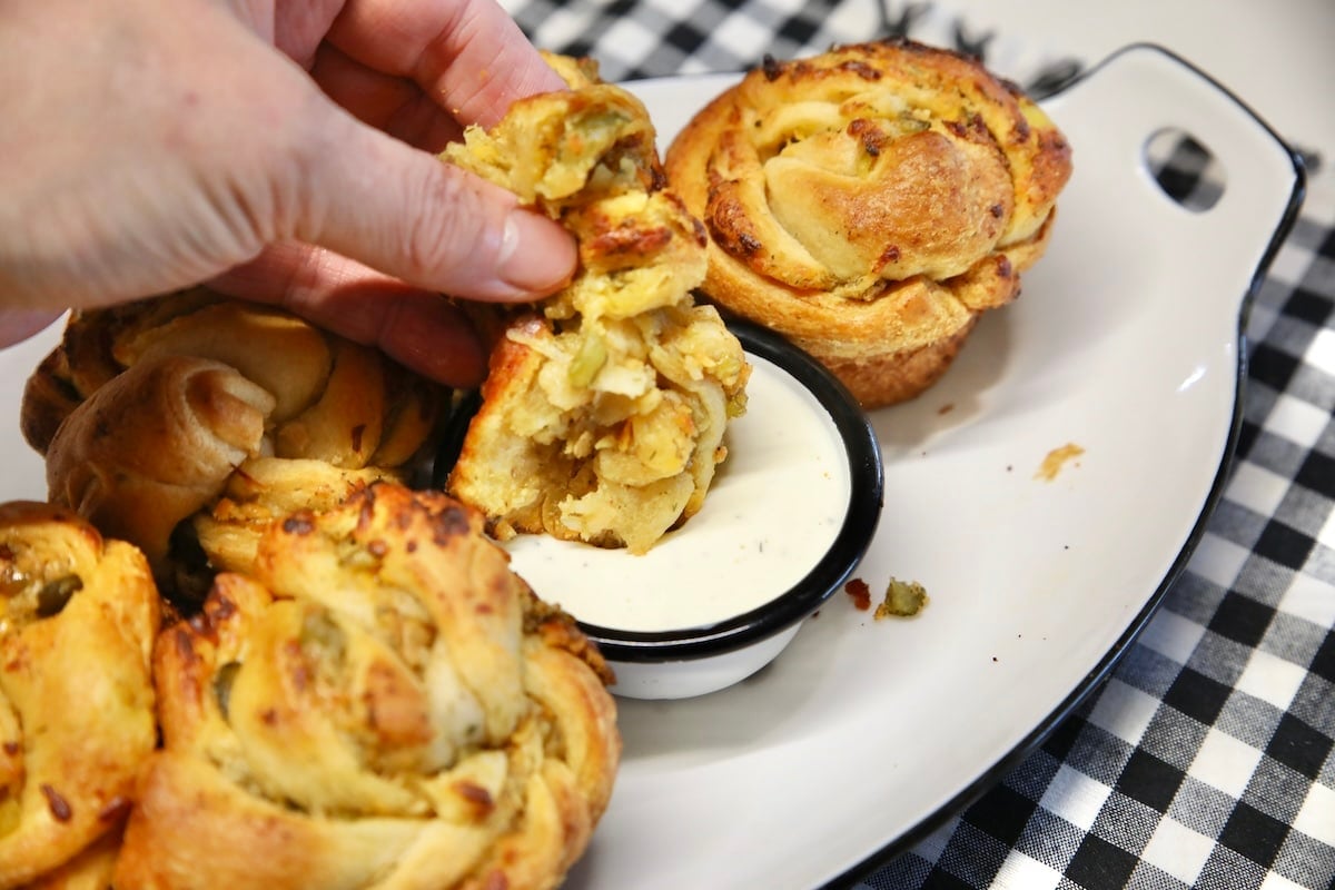 Dipping pickle cruffin into ranch dressing.