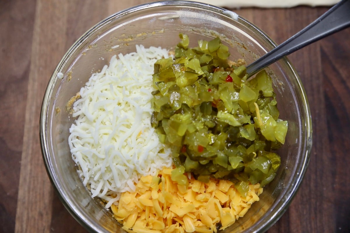 Cheese and pickles in a bowl for cruffin filling.