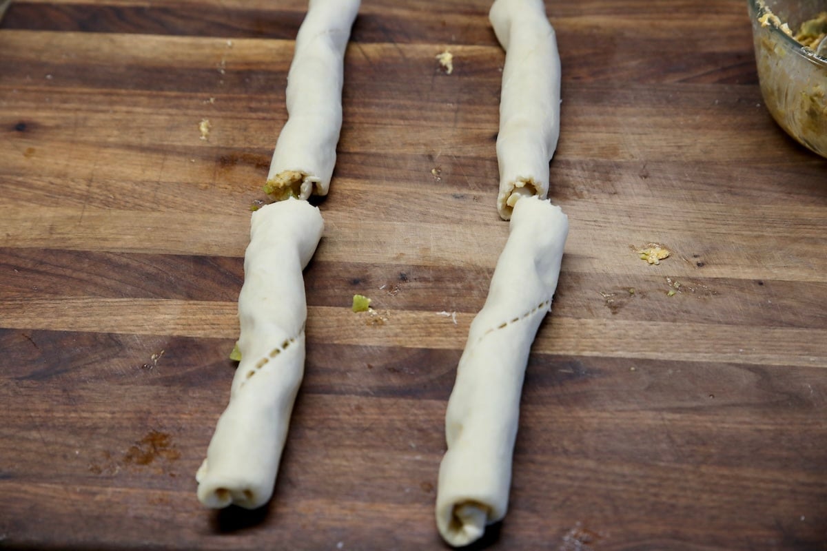 Rolled up crescent dough with pickle filling.