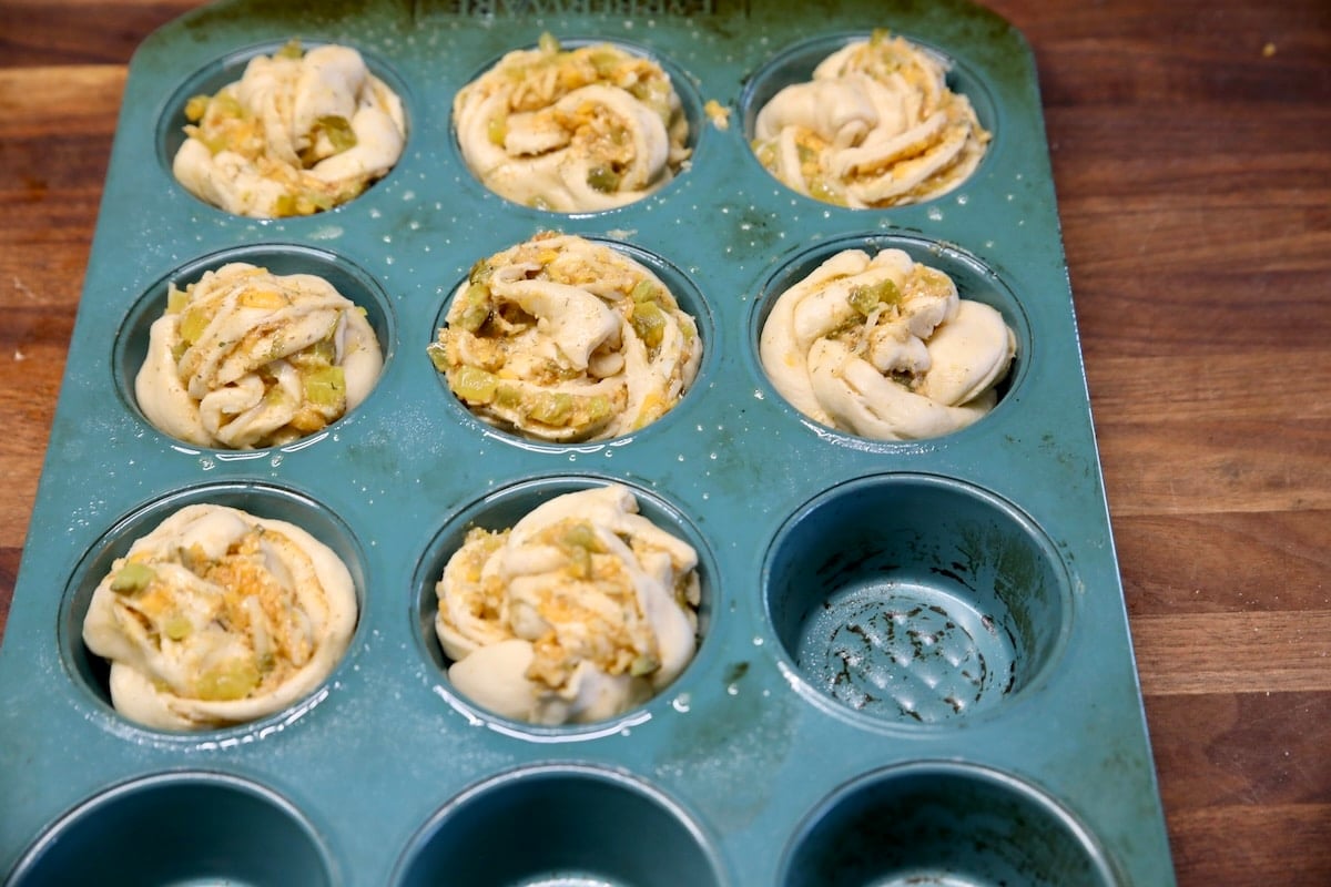 Muffin pan filled with pickle cruffins.