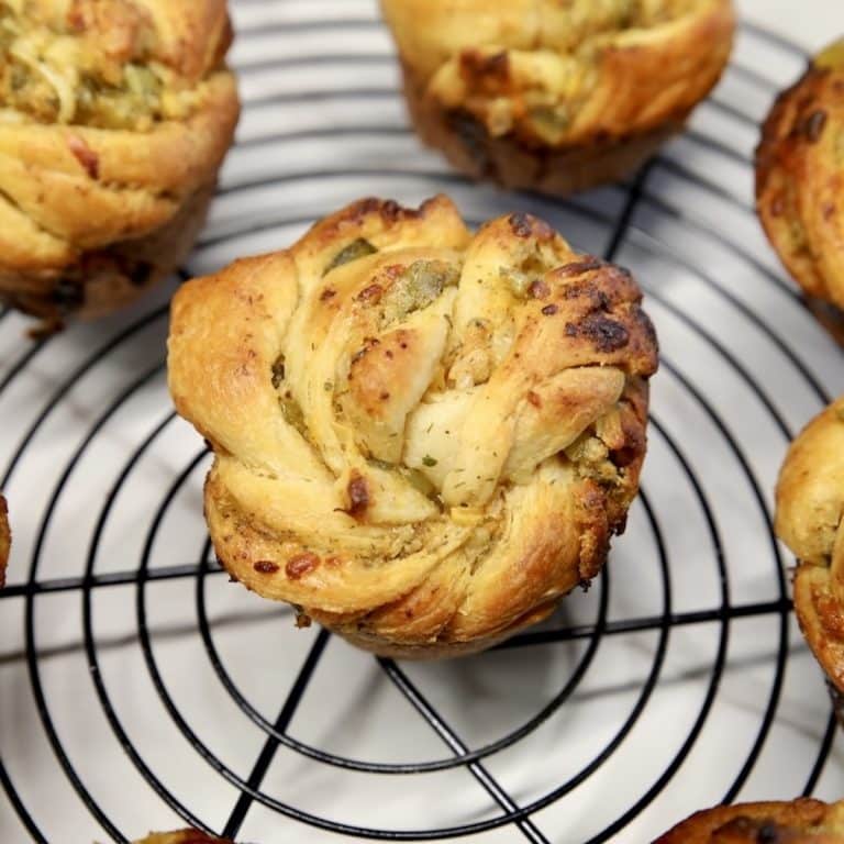 Pickle cruffins on a wire rack.