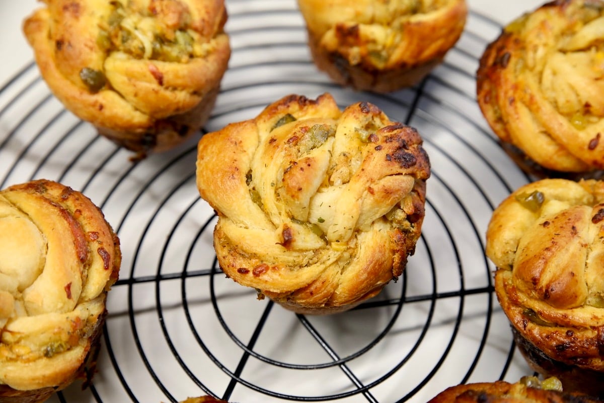 Cheesy ranch pickle cruffins on a wire rack.