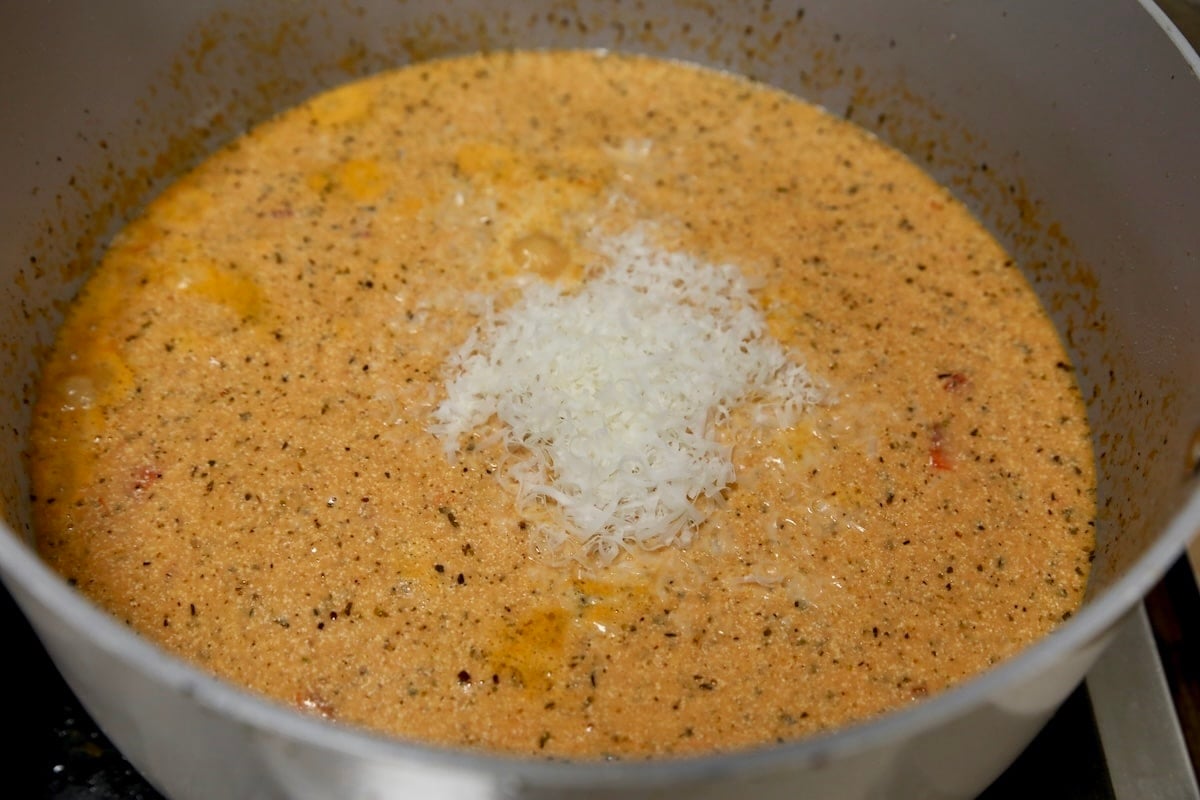 Pan of creamy tomato soup with parmesan cheese.