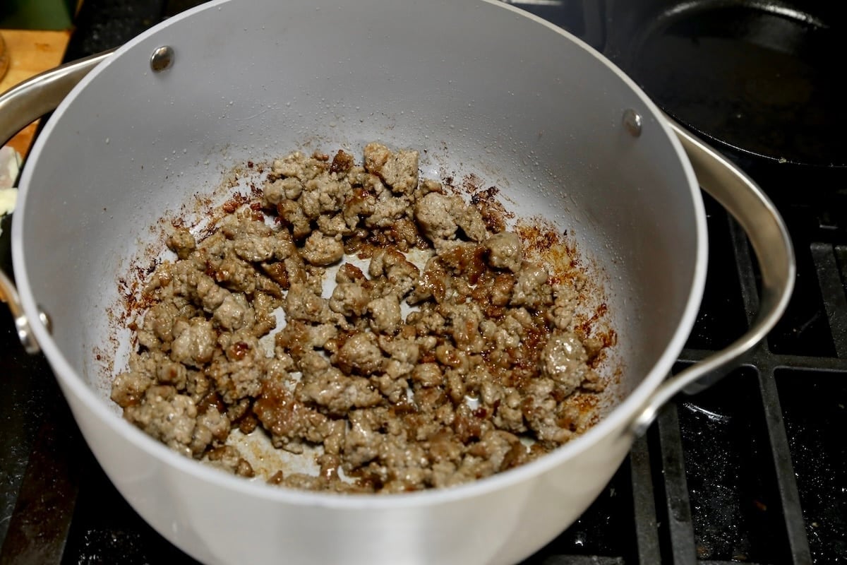 Browned sausage in a pan.