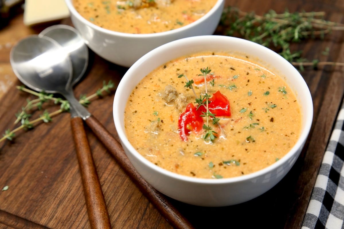 Bowl of creamy tomato soup with sausage.
