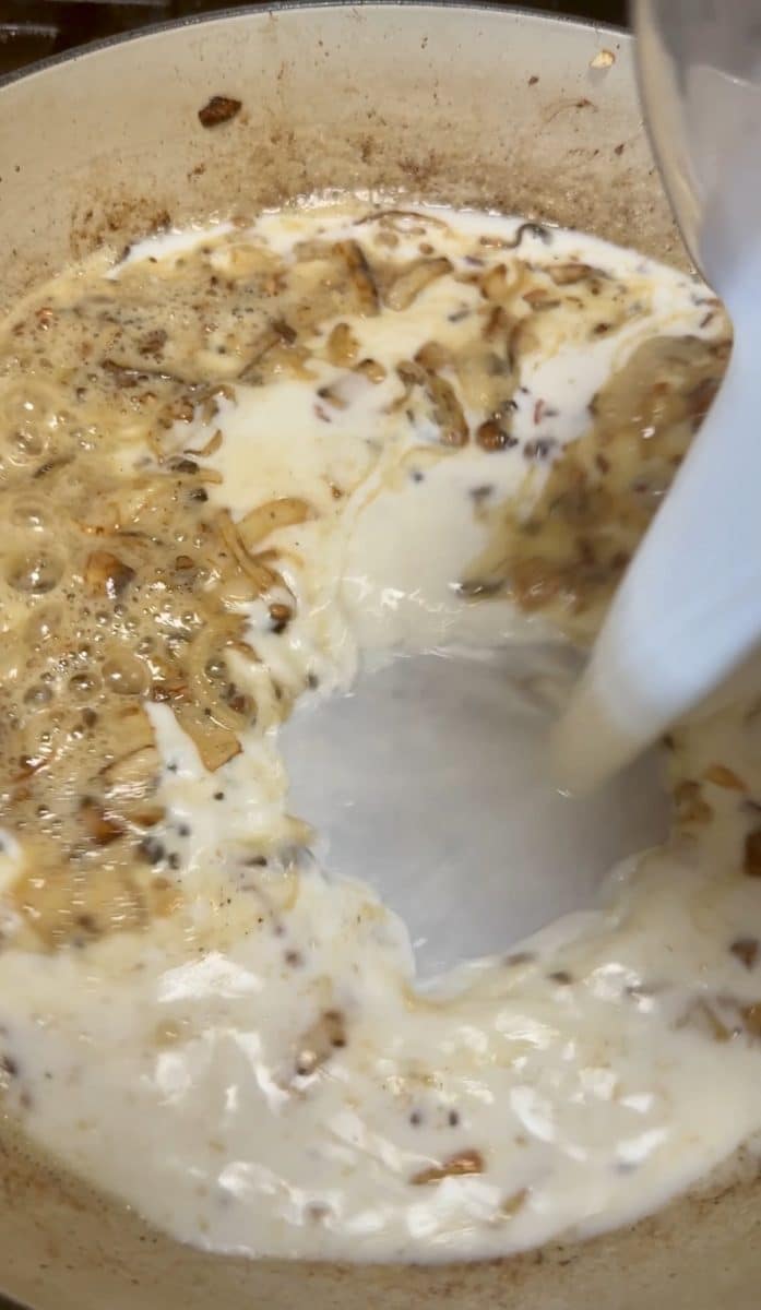 Making cheese sauce with milk.