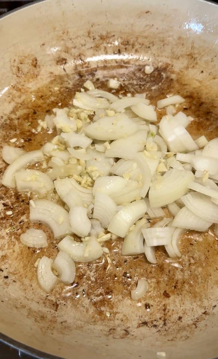 Cooking onions and garlic in a skillet.