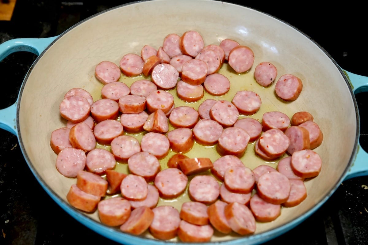 Smoked sausage in a skillet.