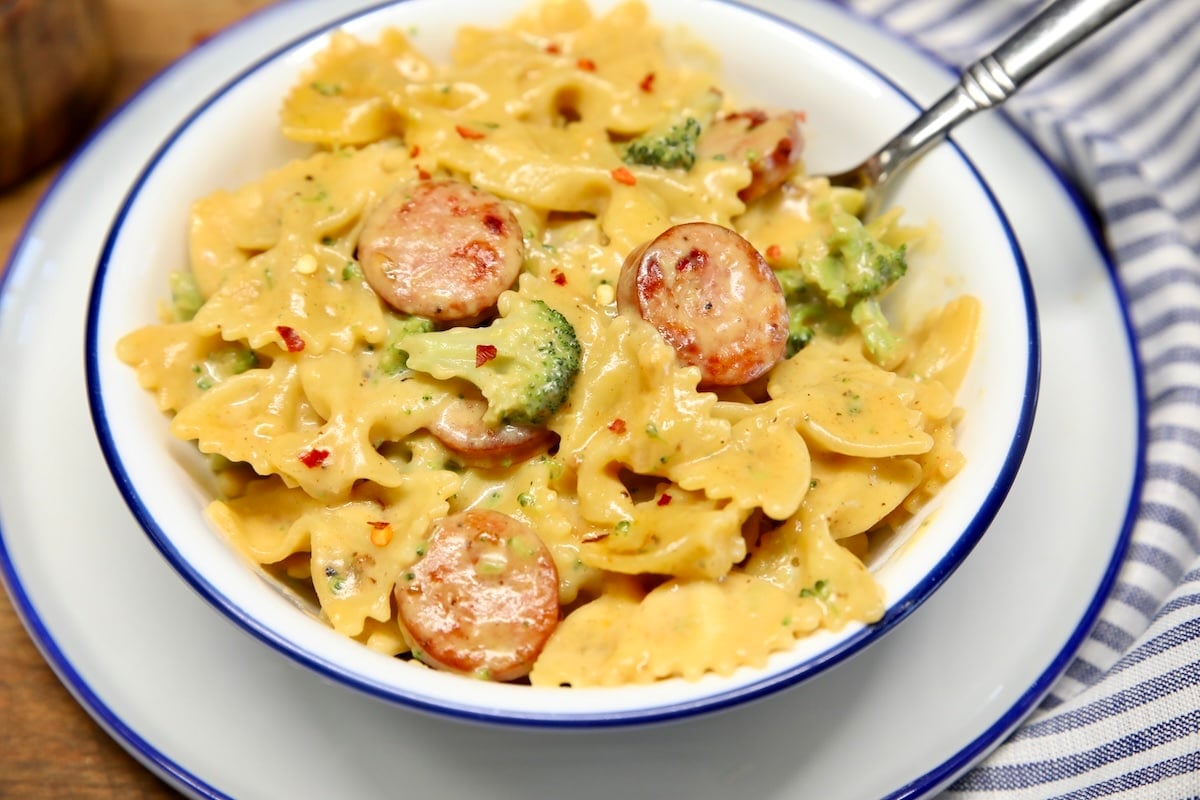 Smoked sausage, broccoli and cheddar pasta. Bowl of smoked sausage cheddar pasta with broccoli.